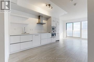 Toronto (Mount Pleasant West) condo for rent - A modern kitchen with white cabinets and a stainless steel range hood.