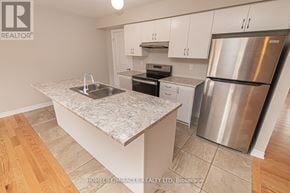 Barrie (Innis-Shore) apartment for rent - A kitchen with a granite countertop and stainless steel appliances.