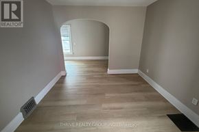 London East (East F) apartment for rent - A room with a wooden floor and a window.