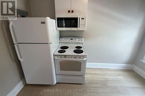 London East (East F) apartment for rent - A white refrigerator and oven in a kitchen.