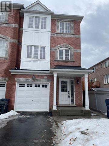 Toronto (Clairlea-Birchmount) townhouse for rent - A red brick house with a white garage door.
