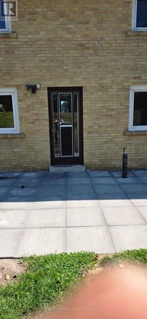 Toronto (Wexford-Maryvale) apartment for rent - A building with a brown door and windows.