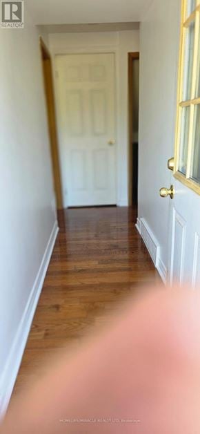 Toronto (Wexford-Maryvale) apartment for rent - A hallway with a white door and wooden floor.