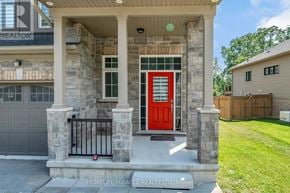 Fort Erie (Ridgeway) apartment for rent - A house with a red door and stone pillars.