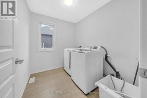 Fort Erie (Ridgeway) apartment for rent - A white laundry room with a washer and dryer.