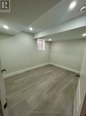 Niagara Falls (Brown) apartment for rent - A room with wooden flooring and white walls.