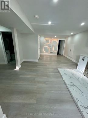 Niagara Falls (Brown) apartment for rent - A spacious room with marble flooring and white walls.