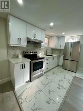 Niagara Falls (Brown) apartment for rent - A white kitchen with marble flooring and stainless steel appliances.