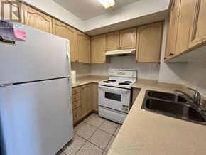 Toronto (Willowdale East) condo for rent - A kitchen with a white fridge, white stove, and a sink.