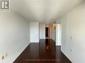 Toronto (Willowdale East) condo for rent - A long hallway with white walls and wood floors.