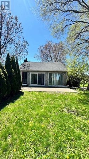 Hamilton (Stoney Creek) apartment for rent - A house with a grey roof and a green lawn in front.