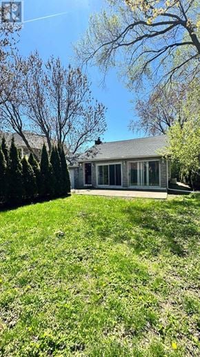 Hamilton (Stoney Creek) apartment for rent - A house with a green lawn and trees in the background.