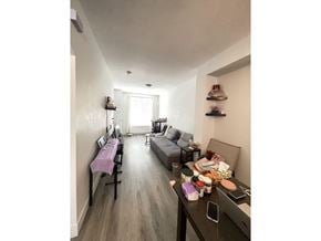 Surrey townhouse for rent - A long hallway with a table and chairs on the left and a couch on the right.
