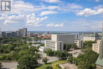 Ottawa house for rent - A cityscape with a large building in the center and a body of water in the foreground.