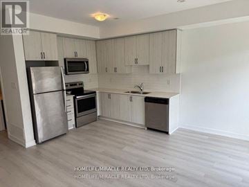 Vaughan (Vaughan Grove) townhouse for rent - A kitchen with a refrigerator, microwave, oven, and sink.
