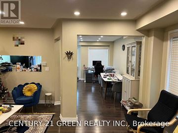 Milton (De Dempsey) apartment for rent - A living room with a blue chair and a dining room table in the background.