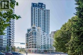 Vancouver apartment for rent - A tall building with the sign REASON on it stands in front of other buildings.