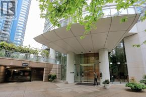 Vancouver apartment for rent - A man is entering a building with a glass door.