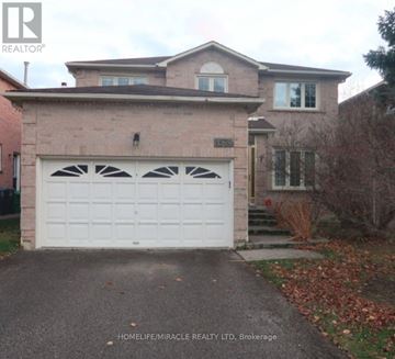 Mississauga (East Credit) apartment for rent - A house with a white garage door in front of it.