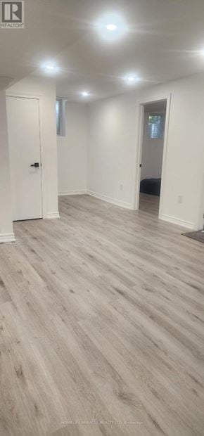Mississauga (East Credit) apartment for rent - A room with a wooden floor and white walls.