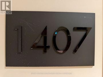 Toronto (Parkwoods-Donalda) condo for rent - A modern kitchen with white cabinets and a black countertop.