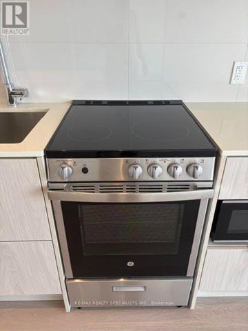 Mississauga (City Centre) condo for rent - A stainless steel oven with a black top is installed in a kitchen.