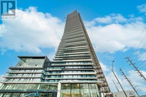 Mississauga (City Centre) condo for rent - A tall building with a glass facade and a sign that reads RE/MAX Realty Specialists.