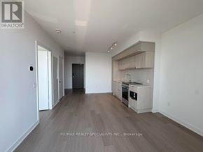 Mississauga (City Centre) condo for rent - A spacious room with a kitchenette and a door to another room.