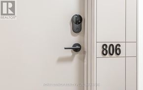 Mississauga (Central Erin Mills) house for rent - A door with a black handle and a number 806 on the wall.