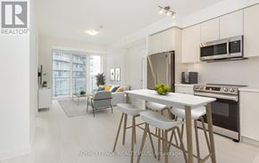 Mississauga (Central Erin Mills) house for rent - A modern kitchen with white cabinets and stainless steel appliances.