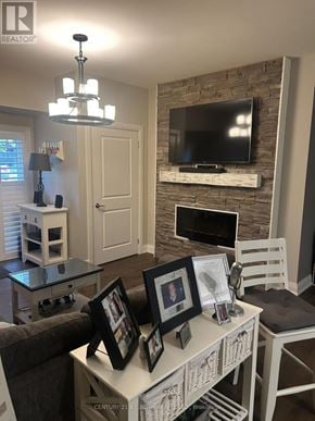 Barrie (Holly) condo for rent - A living room with a white mantle and a flat screen TV mounted on it.
