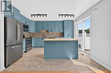 Ottawa apartment for rent - A kitchen with blue cabinets and a wooden counter.