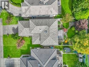 Coquitlam apartment for rent - A bird's eye view of a residential area with houses and green lawns.