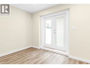 Coquitlam apartment for rent - A room with a white door and wooden flooring.