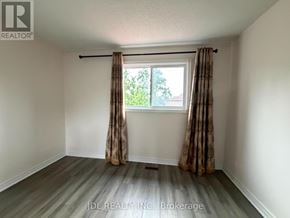Markham (Raymerville) apartment for rent - A room with a window and curtains, and a logo that says "REALTOR".