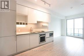 Vaughan (Vaughan Corporate Centre) condo for rent - A modern kitchen with white cabinets and a large island.