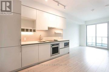Vaughan (Vaughan Corporate Centre) condo for rent - A modern kitchen with white cabinets and a large island.