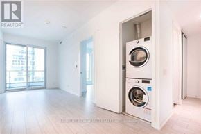 Vaughan (Vaughan Corporate Centre) condo for rent - A realtor photo of a clean, empty room with a washer and dryer in the corner.
