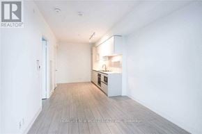 Vaughan (Vaughan Corporate Centre) condo for rent - A spacious, empty room with a kitchenette in the corner.
