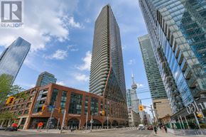 Toronto (Waterfront Communities) condo for rent - A city street with a building that says Dream Home Realty.