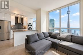 Toronto (Waterfront Communities) condo for rent - A modern kitchen with a large window overlooking the CN Tower.