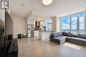 Toronto (Waterfront Communities) condo for rent - A modern living room with a large window overlooking a cityscape.