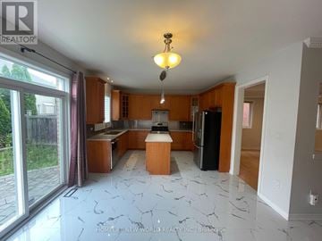 Richmond Hill (Jefferson) apartment for rent - A kitchen with a marble floor and wooden cabinets.