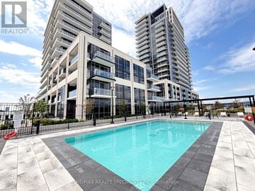 Milton (Tm Timberlea) condo for rent - A modern building with a pool in front of it.