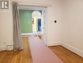 Toronto (Dovercourt-Wallace Emerson-Junction) apartment for rent - A room with a green wall and a doorway leading to another room.