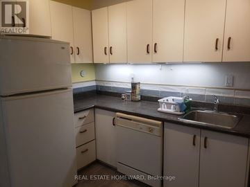 Toronto (Dovercourt-Wallace Emerson-Junction) apartment for rent - A kitchen with white cabinets and a white refrigerator.