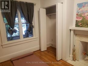 Toronto (Dovercourt-Wallace Emerson-Junction) apartment for rent - A room with a fireplace and a painting of flowers on the wall.