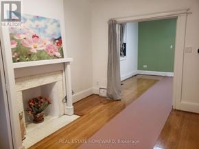 Toronto (Dovercourt-Wallace Emerson-Junction) apartment for rent - A room with a fireplace and a painting on the wall.