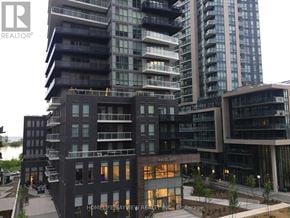 Toronto (Mimico) condo for rent - A modern multi-story building with balconies and glass windows.