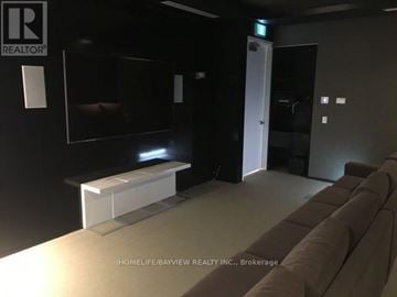 Toronto (Mimico) condo for rent - A modern living room with a couch and a flat screen TV.